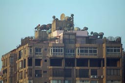 Satelite dishes Cairo appartment block roof.