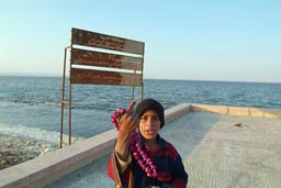 Qarum lake, kid selling shell necklace, Egypt.
