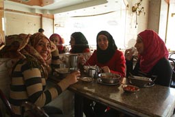 Veiled Muslim girls, eating kushari, Cairo.
