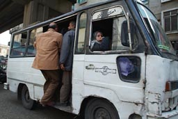 People entering overcrowded bus, Cairo.