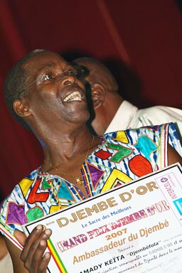 Mamady Keita honoured, djembefola, or djembefolla, djembe percussion ballet made in Guinea. His groups name is Sewakan, Djembe d'or Festival, Conakry Guinea, Guinee.