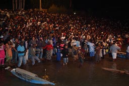 Crowd standing in water. Segou Festival.