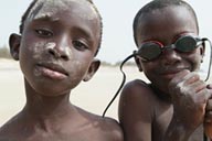 African boys on beach in Djembering.