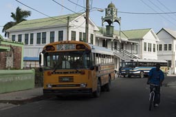 Yellow bus on Regent's Street outside Presbyterian church Belize City.