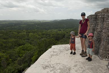 On top of Maya pyramid, Xunantunich, view over jungle, the boys would rather run around..