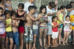 Children holding turtles stand in a line, El Zonte, El Salvador. Turtle project.