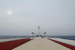 On the cargo ship, hazy morning.