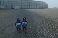 Twin boys in front of Nordkapp building.