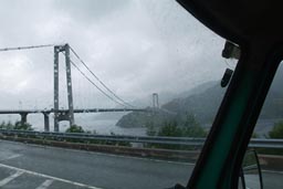 Drive in rain, bridge over fjord.