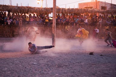 One torero in bullfight in Yucatan, Mexico, goes down, twilight.