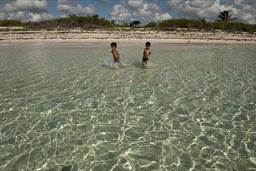 Twin boys run in Ocean on Costa Maya, Quintana Roo, Mexico.