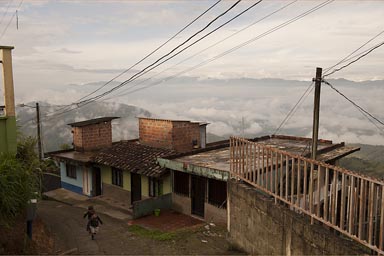 My boys run up a street, early morning Santa Barbara, Antioquia, central Colombia.