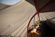 View from sand buggy, down and up a slope, dune in Huacachina.