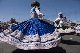 Dresse of folkloric dancers are eleborate bolleras, blue, decorated, Arequipa Day, Peru.