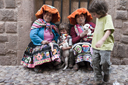 In Cusco, cobble stones and indigenous women in traditional dress, the boys like their lambs and I take a photo for a dollar.