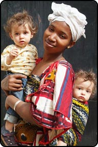 Daniel and David with nanny Aisha, the best we ever had, black African Woman carrying white twin babies, in Bamako, Mali.