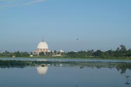 Yamoussoukro, Basilica from far, sea roses in front. reflection of basilica in lake.