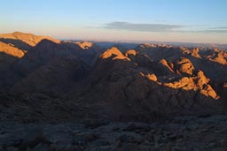 Sun sheds first light on cold desert mountains. Sinai after sunrise.