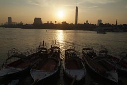Nile and pleasure boats, Cairo tower, smoggy sunset.