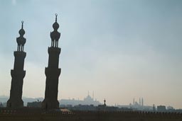 On top of Sultan Muaiyad, Bab Sweila minarets. Other mosques in distance, smoggy Cairo.