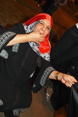 Muslim woman whistling, Cairo street celebrations of CAN football 2010 win.