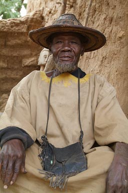 Dogon trader, in his shop, traditional Dogon hat.