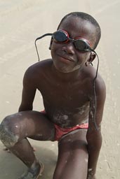 African boy, sunglasses, the ocean, southern Senegal.