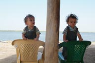 One year old twins, Daniel and David, hungry, when food arrives late.