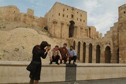 Citadel, Aleppo, 3 men being photographed by lady.