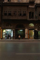 Night, street Aleppo, old wooden house, boy.