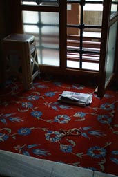 News paper on carpet, plastic stool window, of Sultan Ahmed mosque.
