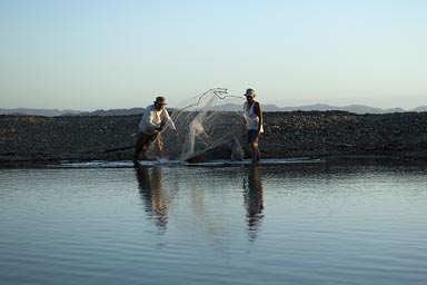 Not so professional Sunday's fishermen from Managua throw their net, El Ostional, Nicaragua.