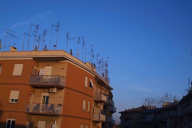 Antennas on a roof, nightly sky.