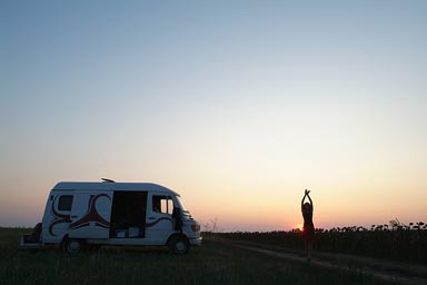 Danube Delta, camp, Christina in front of setting sun, dancing.