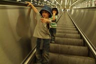 Moving staircase, Stockholm underground, twin boys with hats