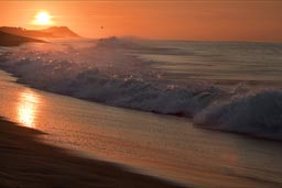 Reflection of sunrise light in wave spume, Baja California Sur.