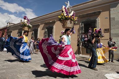 Women carrying flowered baskets. Marriage parade Oaxaca.