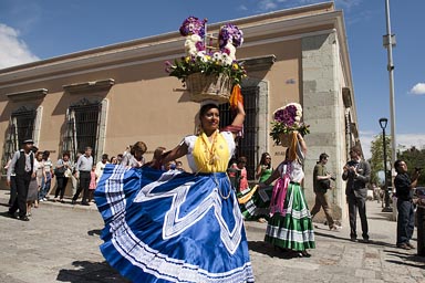 Flower girls in marriage parade, street Oaxaca