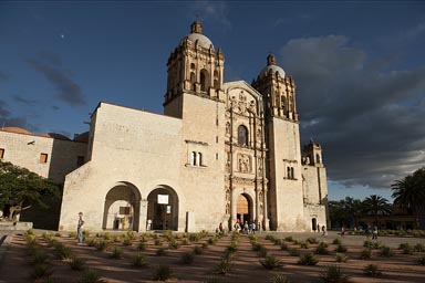 Santo Domingo cathedral, Oaxaca, mescal cacti in front, deep blue evening sky.