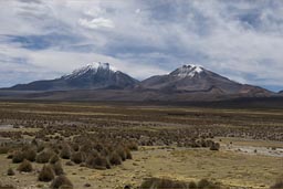 Pomerape, Parinacota in Chile as seen from Bolivia.