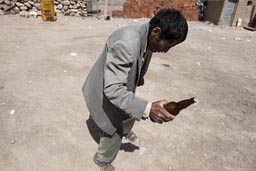 Drunk and dancing with a bottle of beer, man Coipasa, Bolivia, 