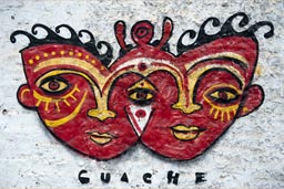 Guache graffiti in Huanchaco, Peru, 2 red masks, 3 eyes.