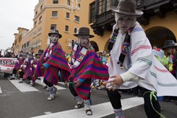 Traditional dances performed by a white masked group, Independence Day in Lima, Peru. 