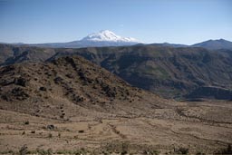 Snow capped Ampato volcanoe sticks out over Andean landscape.