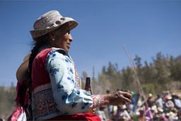 She splashed beer, old Indigenous woman on bull fight, Huambo, Peru,  