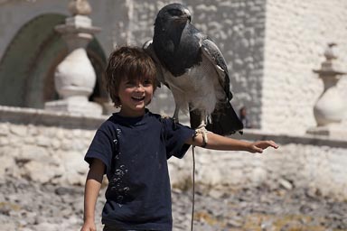 In front of Maca church, David poses with a Condor on sholder, Peru Colca Canyon.