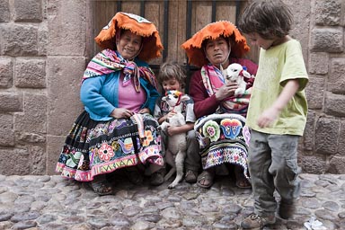 In Cusco, cobble stones and indigenous women in traditional dress, the boys like their lambs and I take a photo for a dollar.
